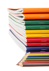 exercise books and pencils, close up.