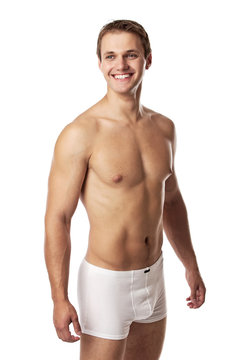 Handsome young man in underwear against white