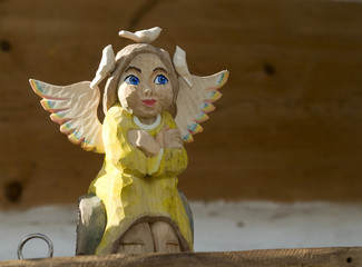wooden angel prying