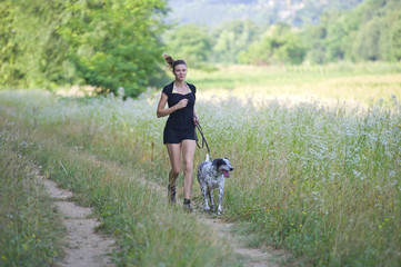 Dogs on leash runs between nature with its proprietary
