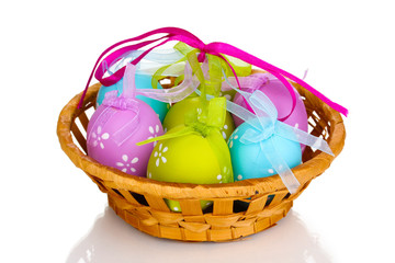 Colorful easter eggs in basket isolated on white