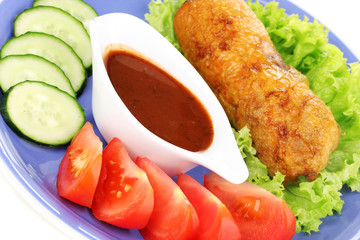Tasty meat cutlet with garnish on plate close-up