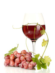 glass of wine and ripe grapes isolated on white