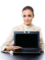 Businesswoman showing laptop with copyspace