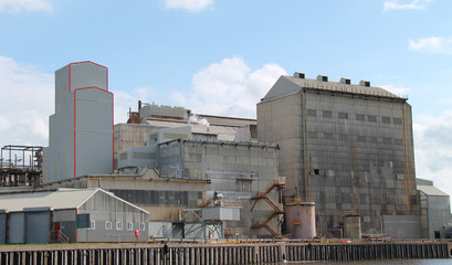 A Large Industrial Factory on a Riverbank.