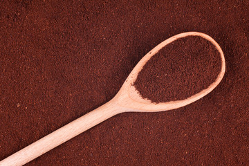 Wooden spoon with ground coffee