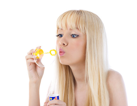 Portrait of a beautiful young woman blowing bubble
