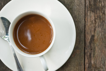 Coffee cup on the wood texture background.