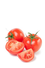 Vertical shot of ripe tomatoes isolated on white