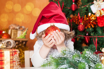 Happy child holding Christmas ball