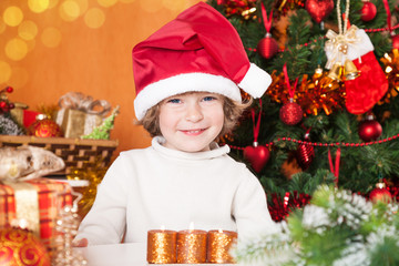 Happy smiling child in Santa`s hat