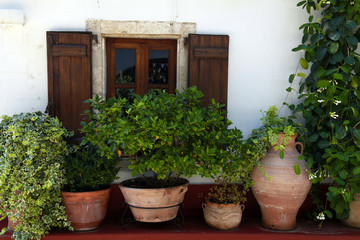 Fototapeta na wymiar Window and flower pots (Crete, Greece)