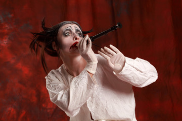 Studio shot of young actress playing old clown