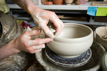 hands of a potter, creating an earthen jar on the circle