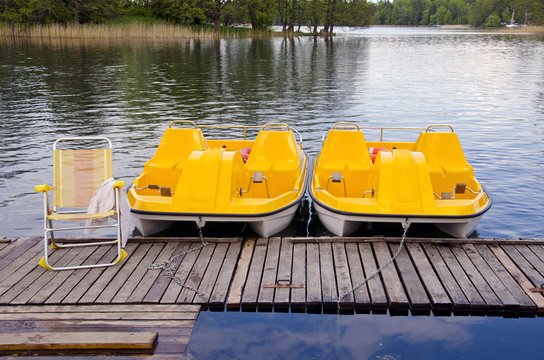 two yellow pedalo on the resort lake