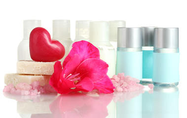 cosmetic bottles, soap and flower, isolated on white.