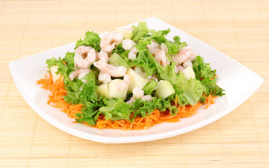 Delicious marinated shrimp in plate on bamboo mat