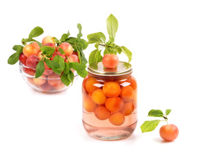 Jar of homemade plum compote, and bowl with fresh fruits