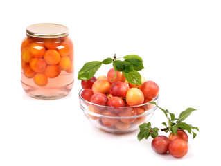 Jar of homemade plum compote, and bowl with fresh fruits