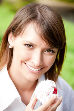 Portrait Of Young Woman With Cake Outdoors