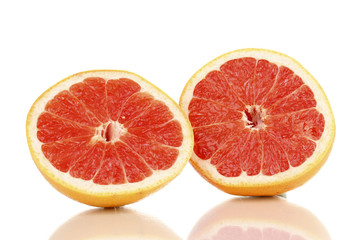Naklejka na ściany i meble Two halves of ripe grapefruit isolated on white