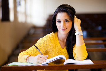 beautiful female college student sitting in classroom