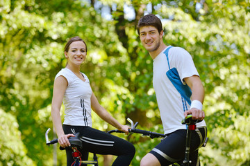 Fototapeta premium Happy couple riding bicycle outdoors