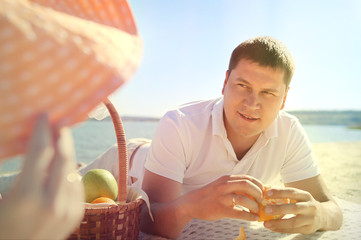 Man cleaning orange peel for his woman