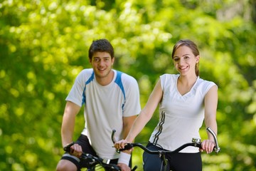 Fototapeta premium Happy couple riding bicycle outdoors