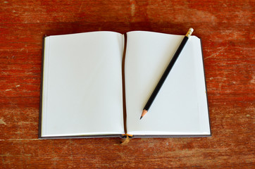 Black pencil on white note book 