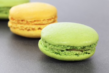 two green and yellow macaroons