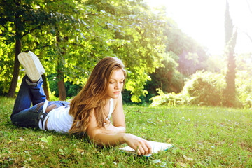 young woman reading in park