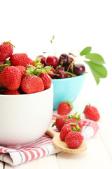Ripe strawberries and cherry berries in bowls