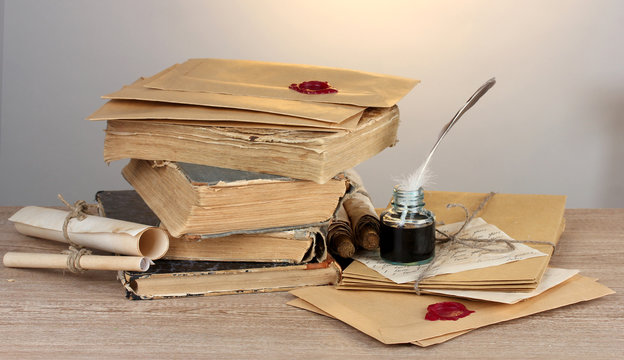 old books, scrolls, feather pen and inkwell