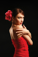Young woman on red dress, isolated on black background