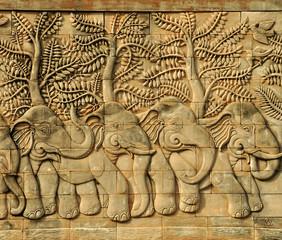 stucco carved wall depicting elephants (all over one's body)