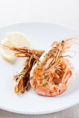 Plate of grilled shrimp with lemon and parsley