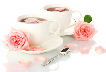 Fototapeta na wymiar cups of tea with roses isolated on white