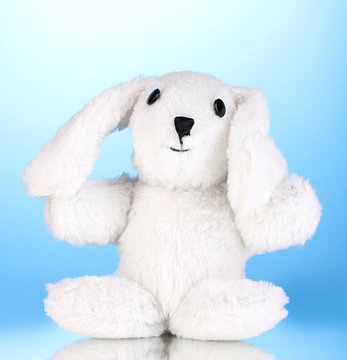 Toy bunny on blue background