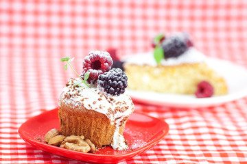 muffin with whipped cream, cake with icing, raspberry, blackberr