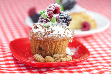 muffin with whipped cream, cake with icing, raspberry, blackberr
