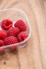 Raspberries on wooden background