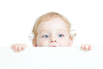 Curly cute child holding blank advertising banner