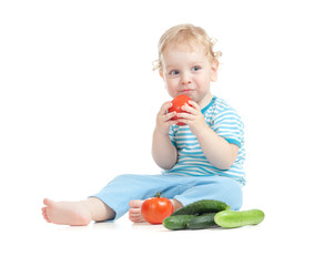 Happy child eating tomatoes. Healthy food eating concept.