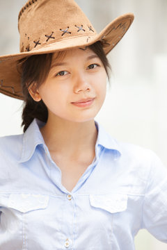 asian woman wearing a hat with smiling face