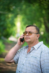 Caucasian man with cell phone in nature