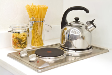 Modern kitchen. Steel pot and pan on the induction cooker
