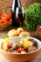 Meatballs with tomato sauce with potatoes in broth