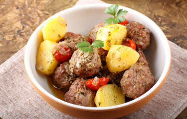 Meatballs with tomato sauce with potatoes in broth