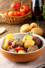 Meatballs with tomato sauce with potatoes in broth